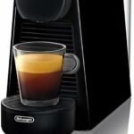 Black De’Longhi single-serve pod espresso machine with a small glass espresso, featured in a Quiet Coffee Makers for Couples roundup.